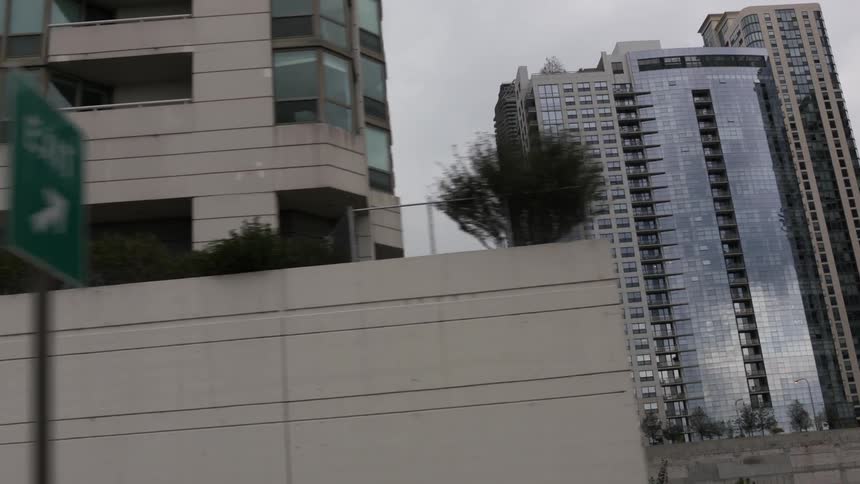 Traveling past buildings and skyscrapers in a city