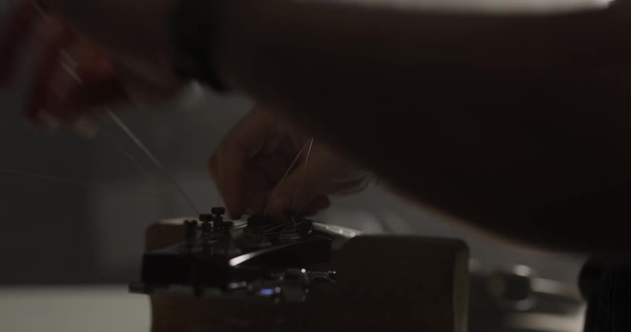 Man Making Guitar In Workshop