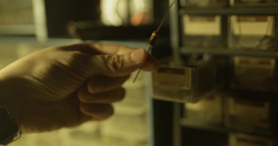 A person getting a resistor out of a drawer