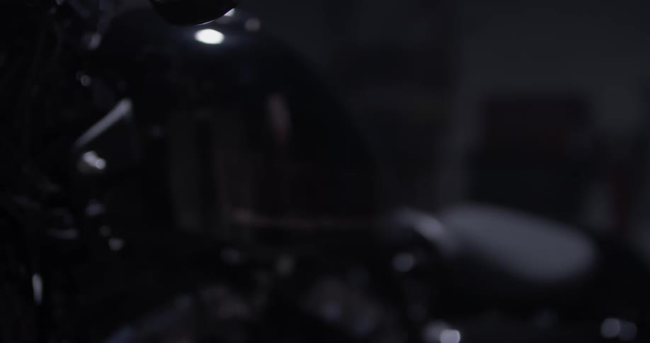 Dark room, eventually focusing on motorcycle