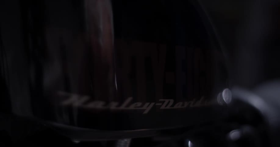 Reflection of motorcycle showing man's face