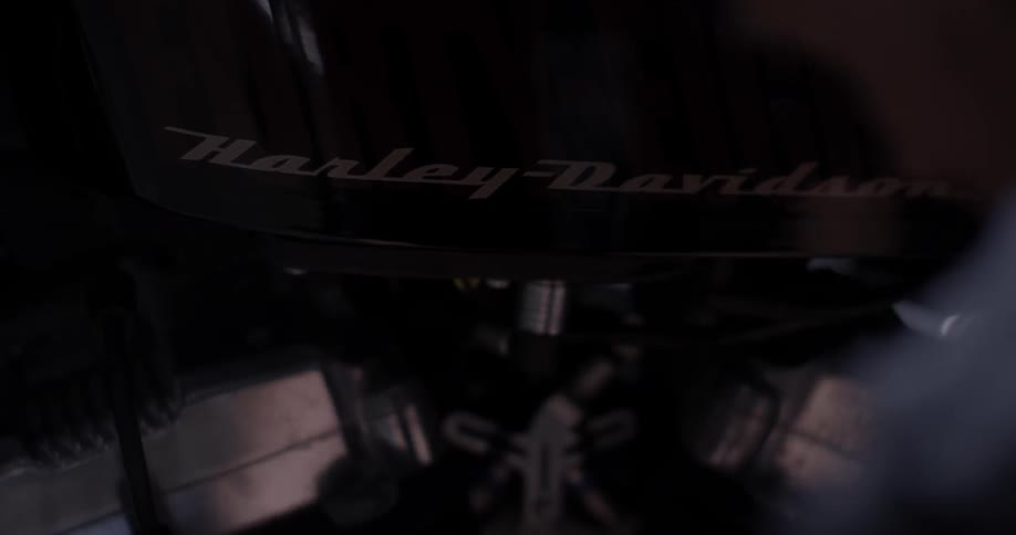 A person is using a wrench on a motorcycle