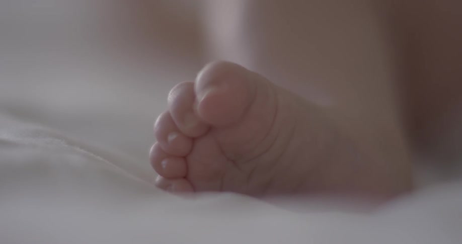 A baby is moving its foot