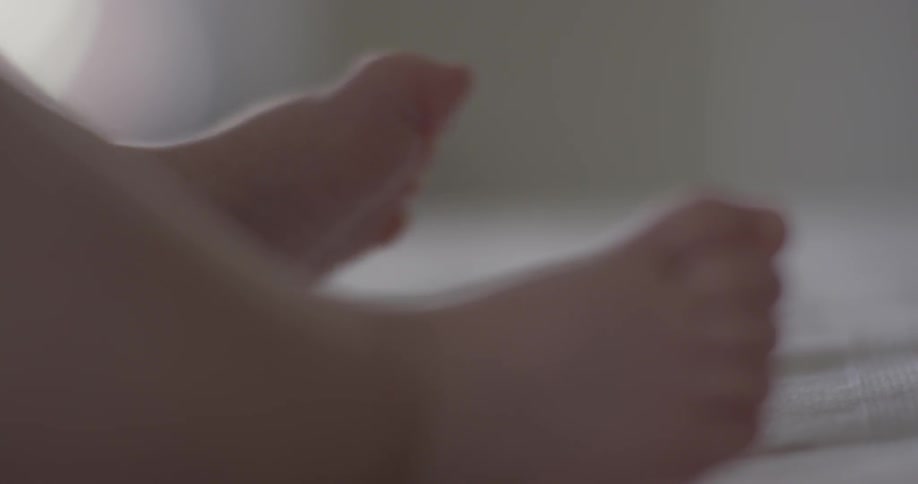 A baby moves its feet around
