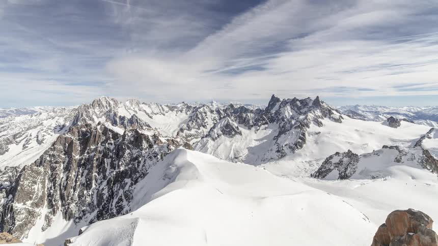 Time lapse of clouds over snow covered mountains