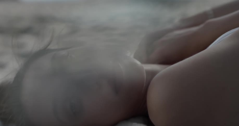 A woman is laying down on the ground