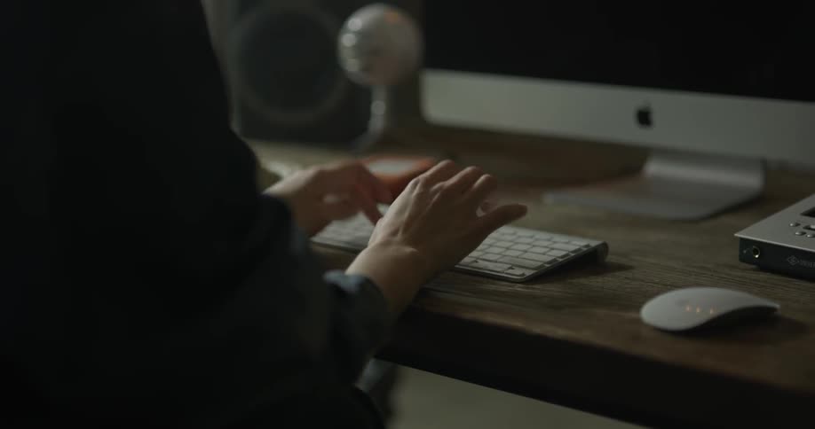 Woman types on thin white keyboard