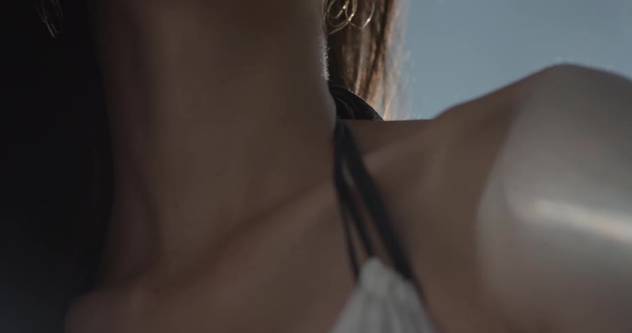 Woman stands outside in the sun