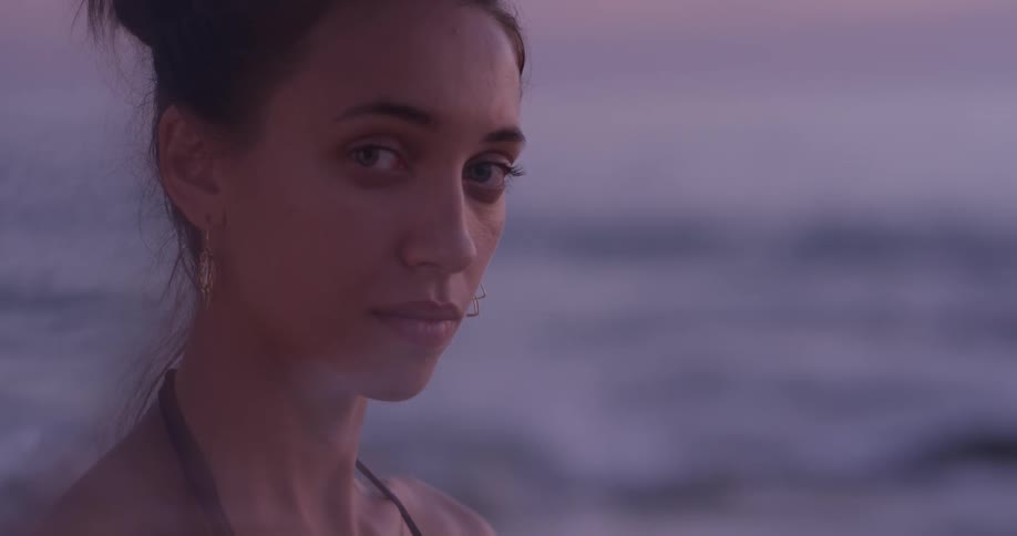 A woman is outside by the beach