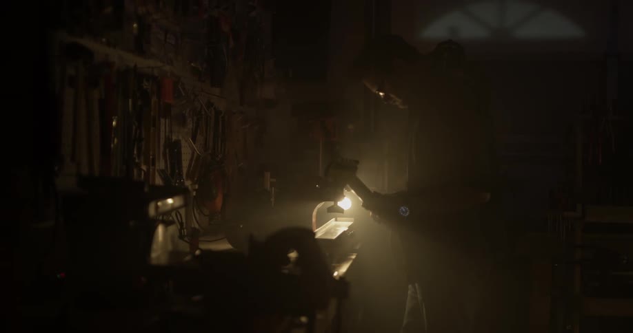 Man working in a dark workshop