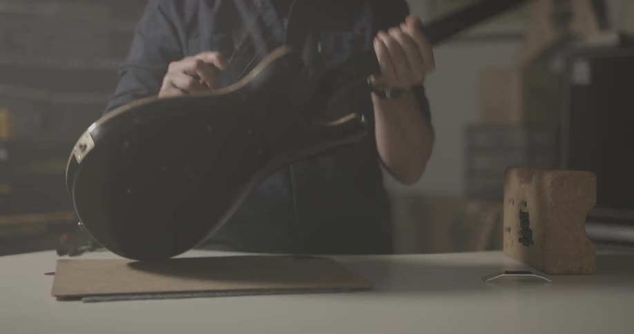 Man looks happily at guitar after installing whammy bar