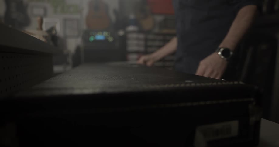 Man opens guitar case