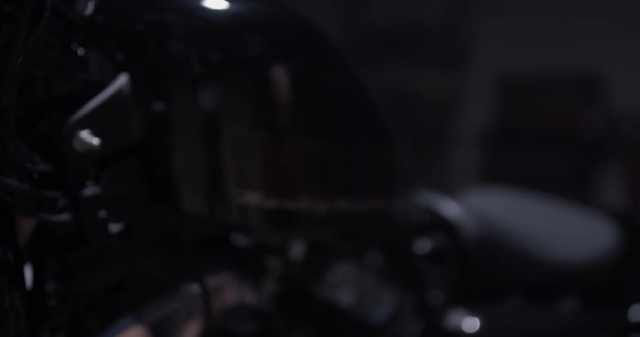 An elderly man polishes a harley motorcycle