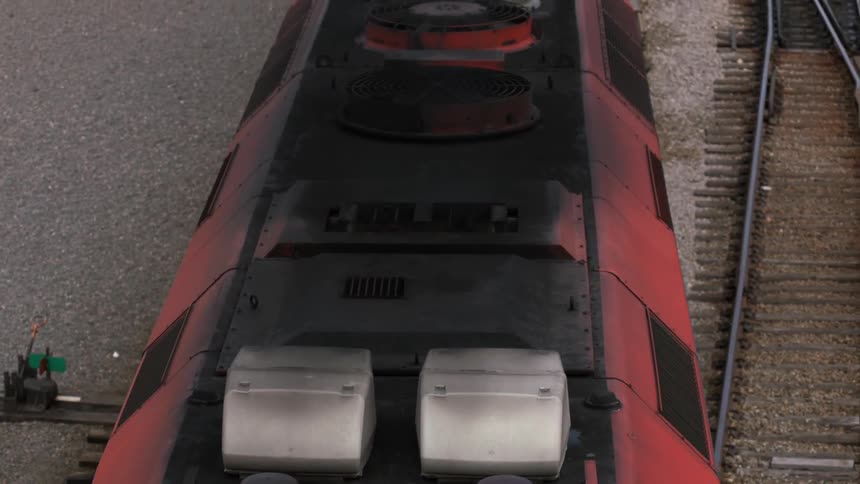 Footage of a passenger train slowly moving over the train tracks