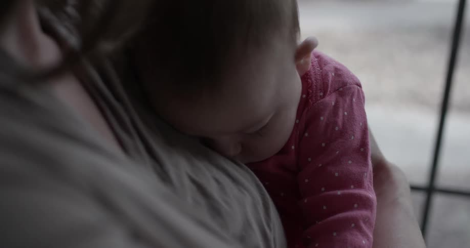 Woman holds baby indoors