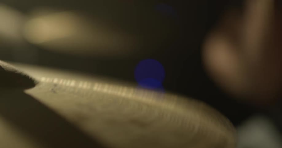 A cymbal vibrates after it's hit with a drumstick
