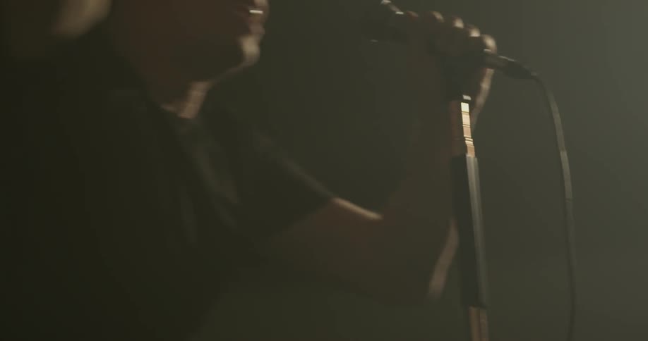 A man with a microphone sings into it