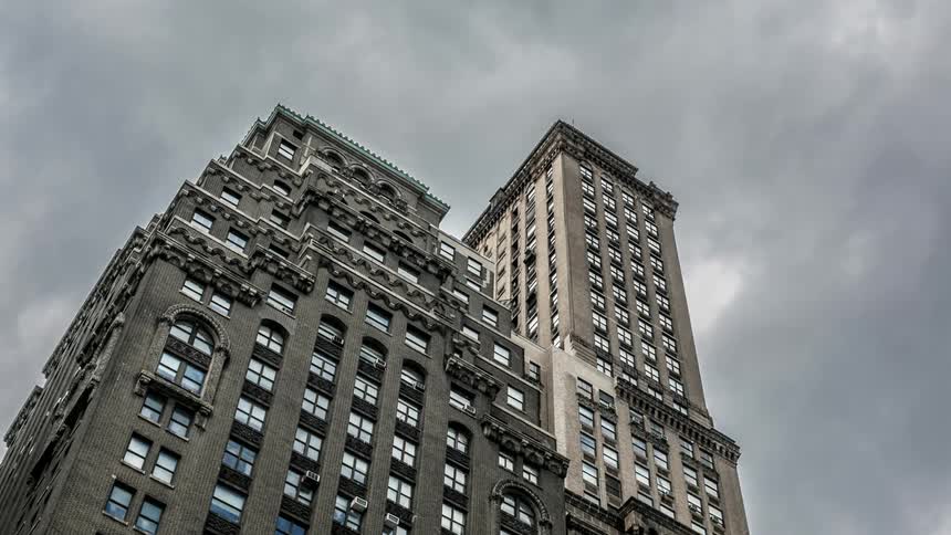 Clouds pass over tall buildings in the city