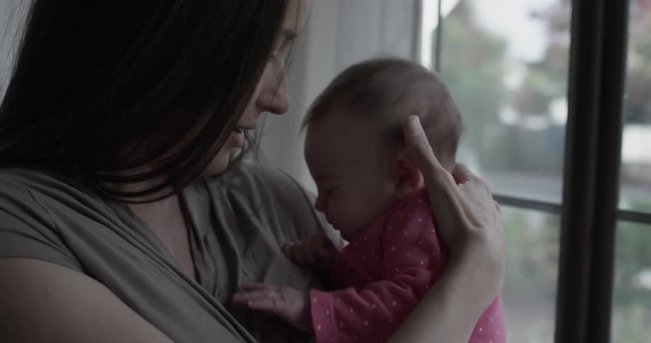 A woman holds a fussing baby