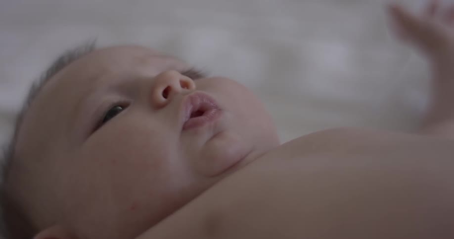 A baby is moving on a bed