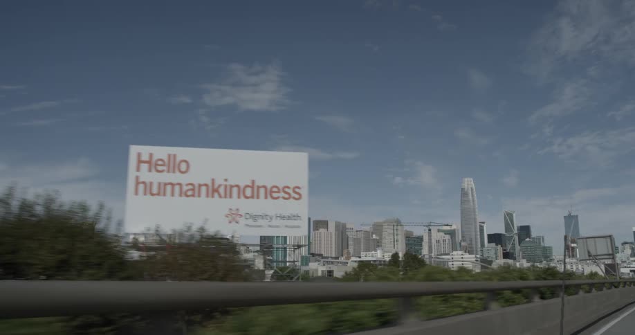 Driving on a highway while the city looms in the distance