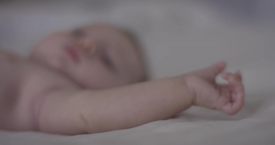 Close up of baby's hand while lying on back