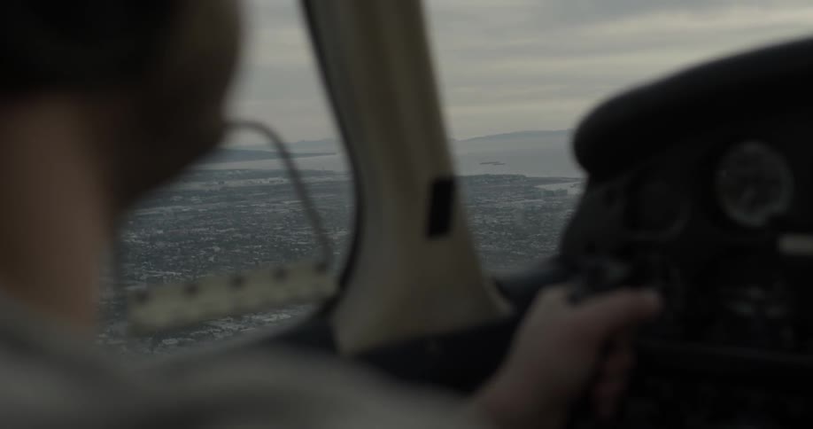 Man pilots airplane over city