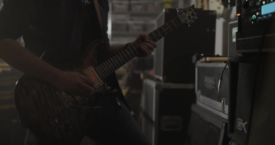 Man Making Guitar In Workshop