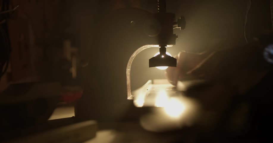 A machine is lifting to pull out a piece being worked on