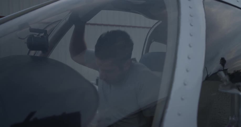 A man gets in the right side of a vehicle