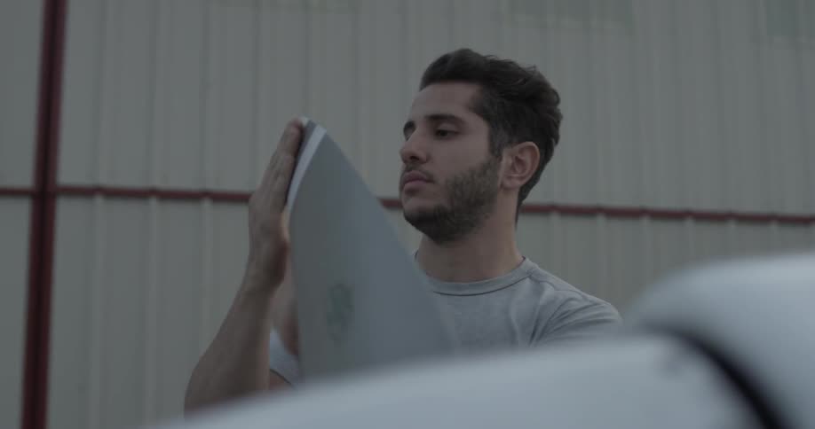 A man is inspecting a wing of something