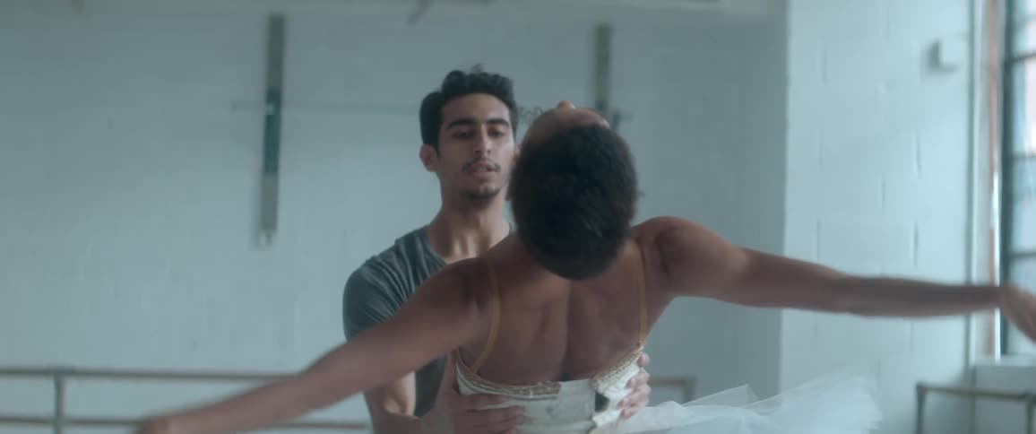 Man helps a woman practice ballet