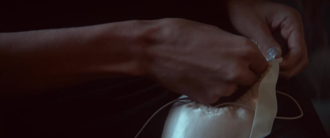 Woman lacing ballet slippers