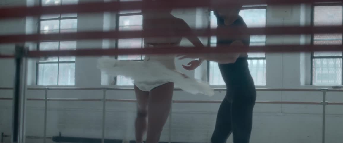 Man helps a woman practice ballet