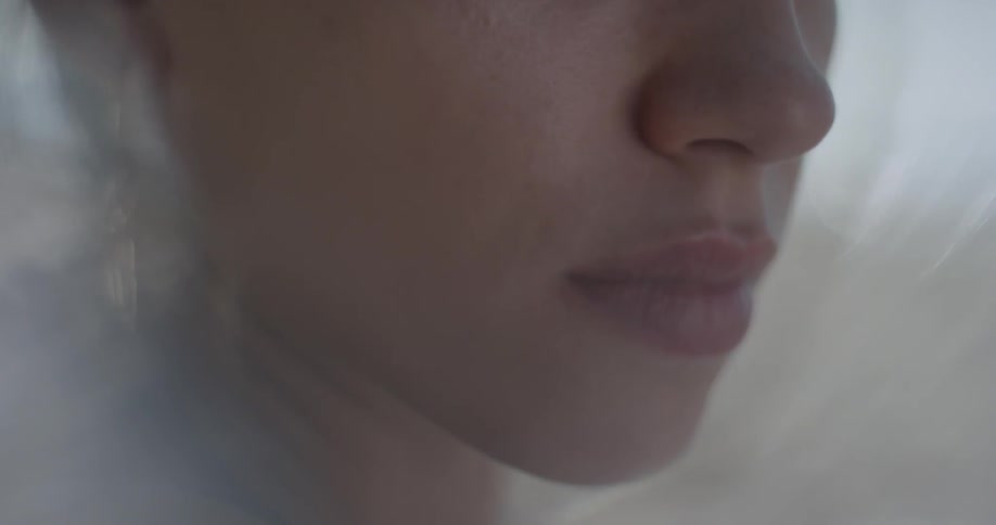A woman is staring and moves her head upwards