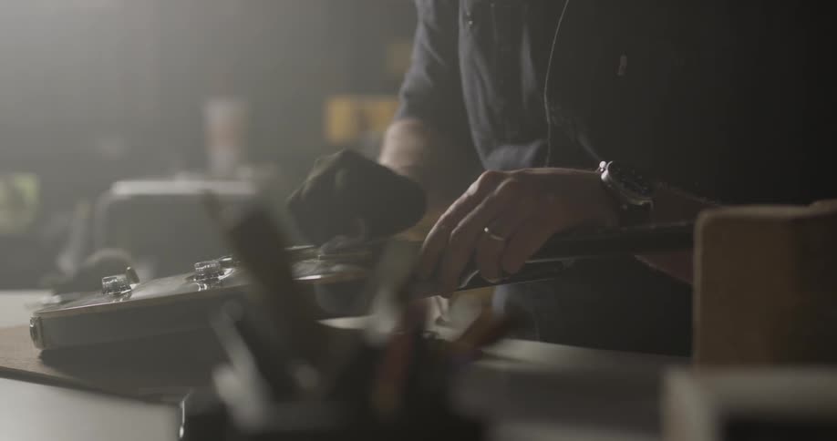 A man polishing a musical instrument