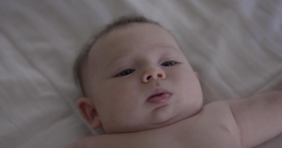 Baby looks around and makes faces