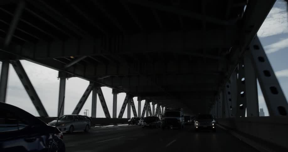 Cars drive along under overpass