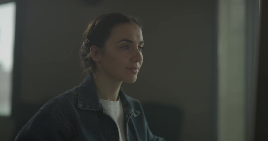 A woman is looking at a screen