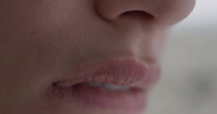 A woman smacks her lips together