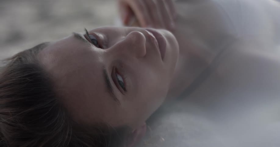 A woman is laying down indoors