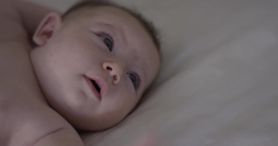A baby laying on a bed