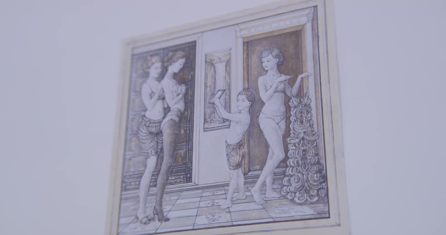 A old historical painting of a child and three women hangs on a white wall