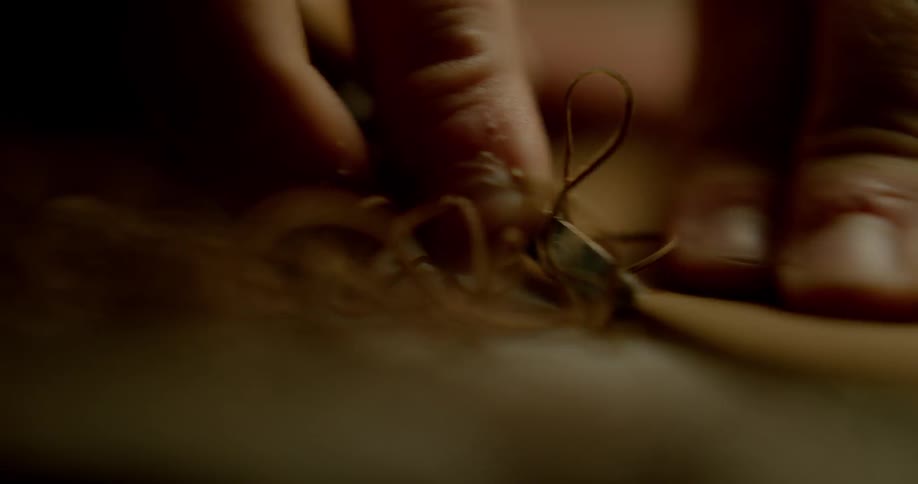 A piece of leather is scraped into a proper size
