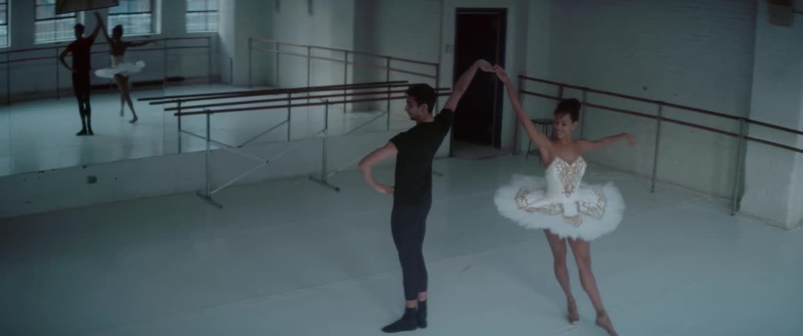 A man and woman dancing ballet in a ballet studio