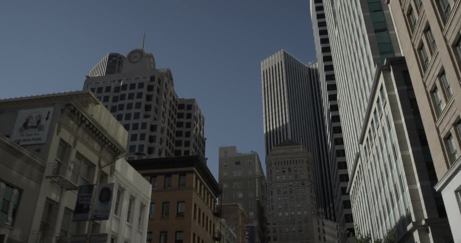 Moving down city street looking up at buildings