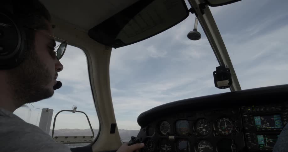Pilot looks around at the cockpit