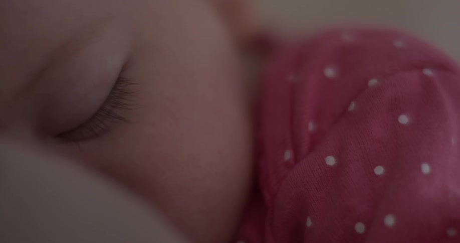 Toddler fast asleep on a light brown pillow