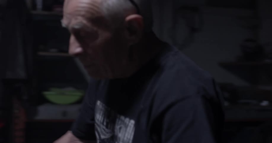 Man walks to motorcycle and checks it