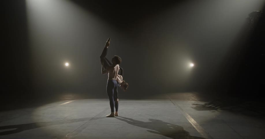 A man and woman dance on stage